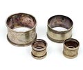  Four plated metal napkin holders design execution unknown one is marked Christofle 