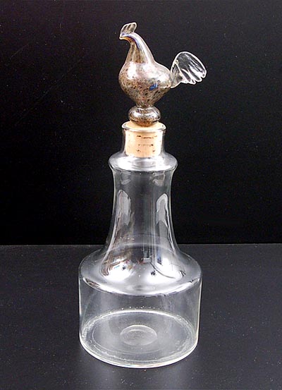 Clear glass decanter with multi coloured stopper shaped like a rooste r fitted in cork design Kaj Franck 1957 executed by Nuutajärvi Notsjö / Finland 