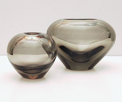 Two smoke colored vases 1x ball 1x heart-shape design Per Lütken 1957 executed by Holmegaard / Denmark Sizes Ball height 8,5 cm Heart height 10,5 cm / wide 14,8 cm 