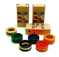 Meerkleurig uitgevoerde beukenhouten servetringen 3 doosjes met ieder 2 stuks ontwerp Ettore Sottsass 1994 uitvoering Twergi Alessi / Italië 