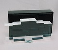 Plexiglazen object in zwart plexiglazen doos tevens voet met schuifdeksel ontwerp uitvoering Dick Cassée 1971 Ontworpen voor de speciale gelegenheid van Europalia jaarlijks Internationaal evenement bedoeld om het publieke bewustzijn van het culturele erfgoed van het gastland te verbeteren 