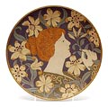 Steengoed wandschotel met ingekerfde en gekleurde decoratie van vrouw met orchideeën ontwerp L.Chevroton 1899 uitvoering Villeroy Boch / Mettlach Saar / Duitsland 